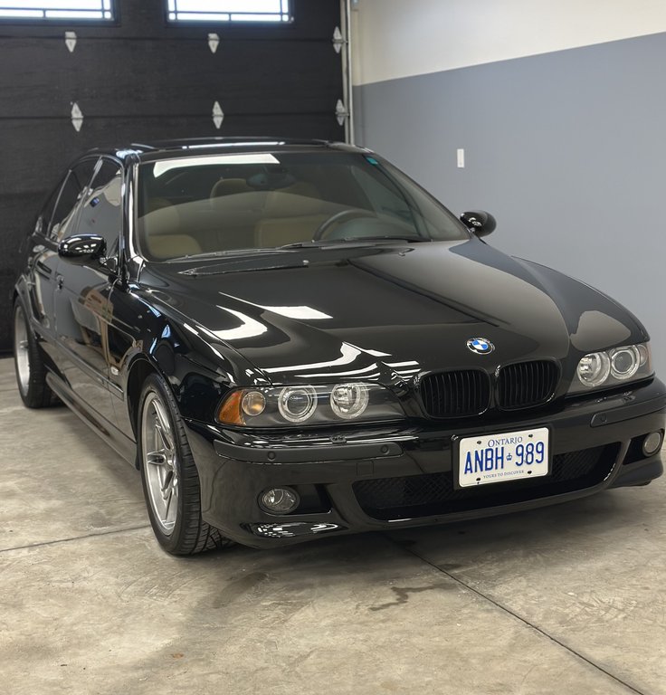 BMW M5 with mirror-like finish after comprehensive paint correction and ceramic coating