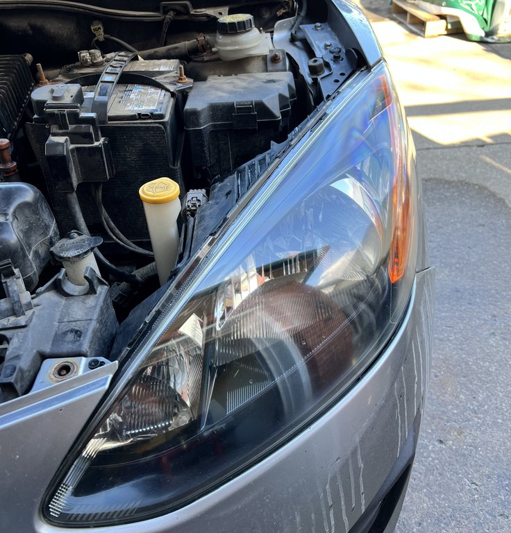 Headlight restoration before showing cloudy, oxidized plastic lens