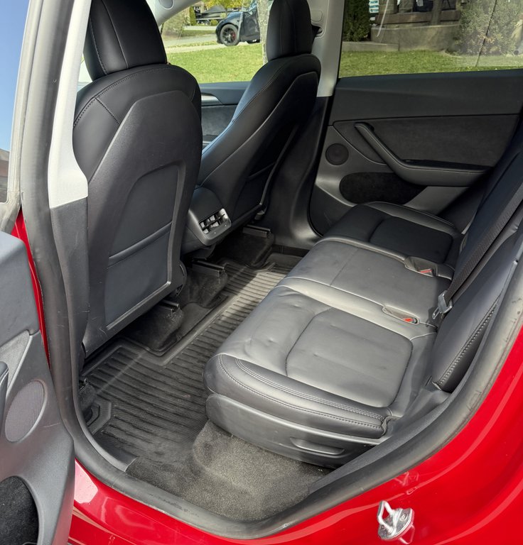 Tesla Model Y electric vehicle after ceramic coating application with hydrophobic finish